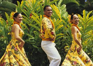 Three dancers in yellow Hawaiian costume