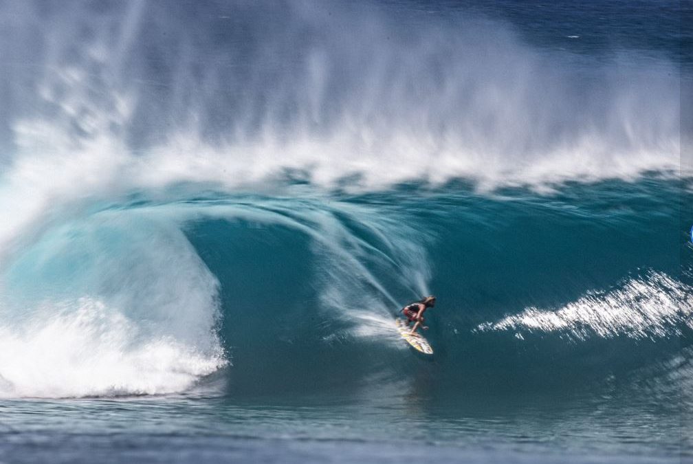 Surfer riding high wave