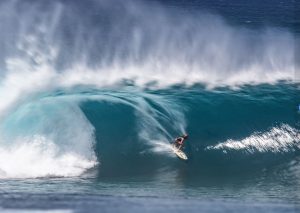 Surfer riding high wave