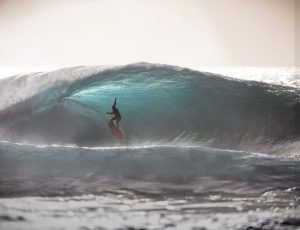 Surfer shooting the curl at Pupukea, Oahu North Shore.